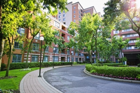 15391773 - circular driveway and sidewalk at brick condominium building
